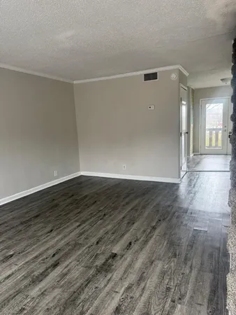 a view of a room with wooden floor