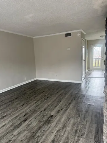 a view of a room with wooden floor