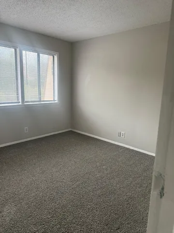 an empty room with a windows and closet