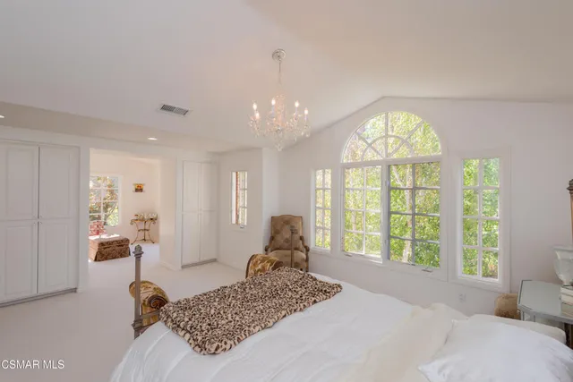 a bedroom with a large bed and a large window