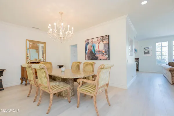 a view of a dining room with furniture and chandelier