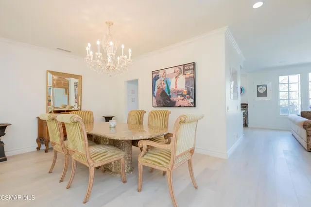 a view of a dining room with furniture and chandelier
