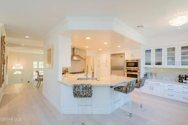 a large kitchen with a large counter top appliances and cabinets