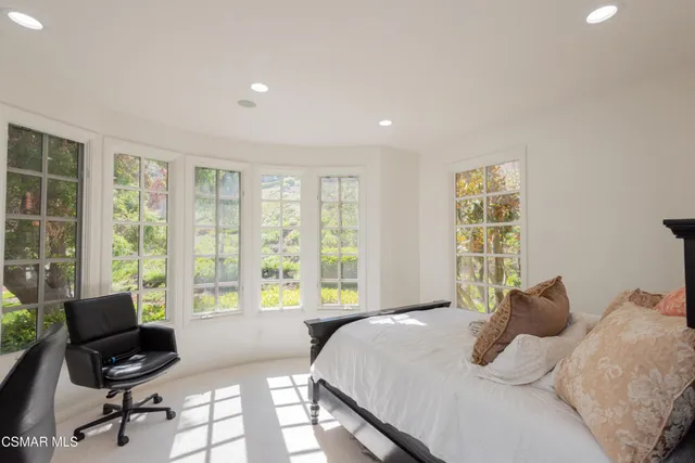 a bedroom with a bed and a desk