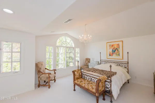 a spacious bedroom with a bed and a couch