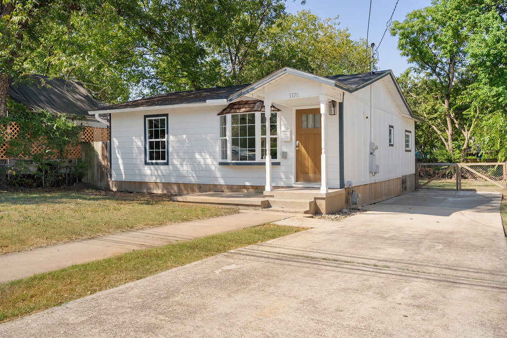 1176 Graham Street Austin, TX 78702 - Photo 2 of 20 a front view of a house with a yard and garage