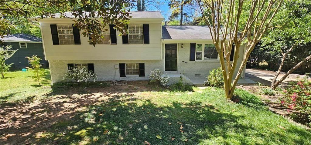 1096 Deleon Court Clarkston, GA 30021 - Photo 1 of 59 a front view of a house with a yard