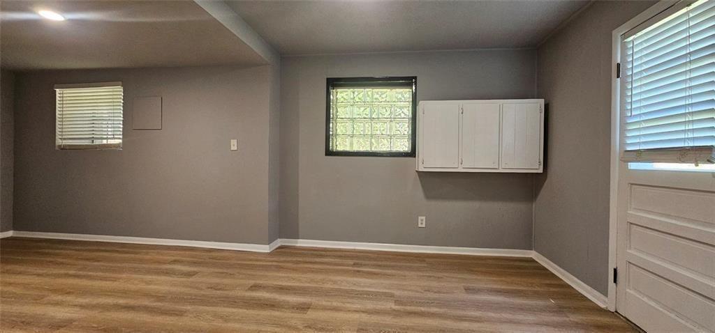 1096 Deleon Court Clarkston, GA 30021 - Photo 19 of 59 an empty room with wooden floor and windows