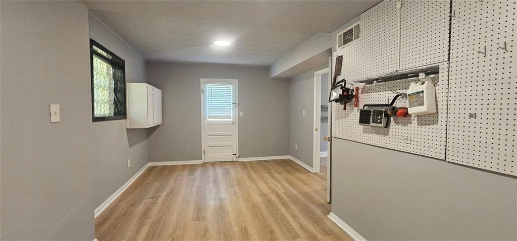 1096 Deleon Court Clarkston, GA 30021 - Photo 20 of 59 a view of hallway with a large window and wooden floor