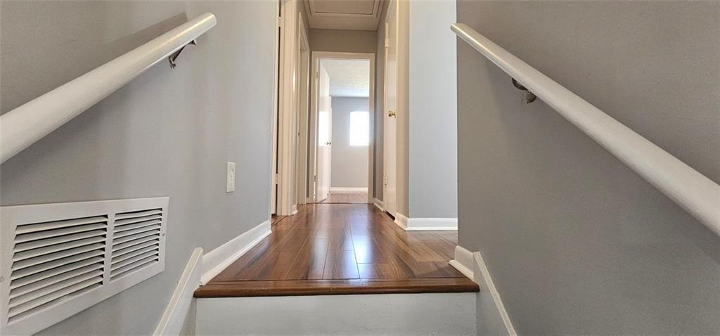 1096 Deleon Court Clarkston, GA 30021 - Photo 23 of 59 a view of a hallway with wooden floor and staircase