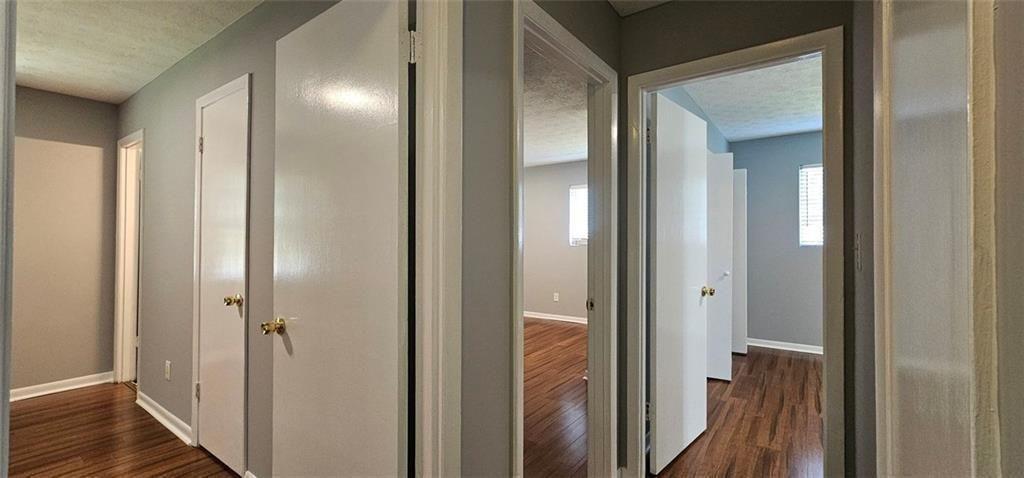 1096 Deleon Court Clarkston, GA 30021 - Photo 24 of 59 a view of a bathroom from a hallway with wooden floor