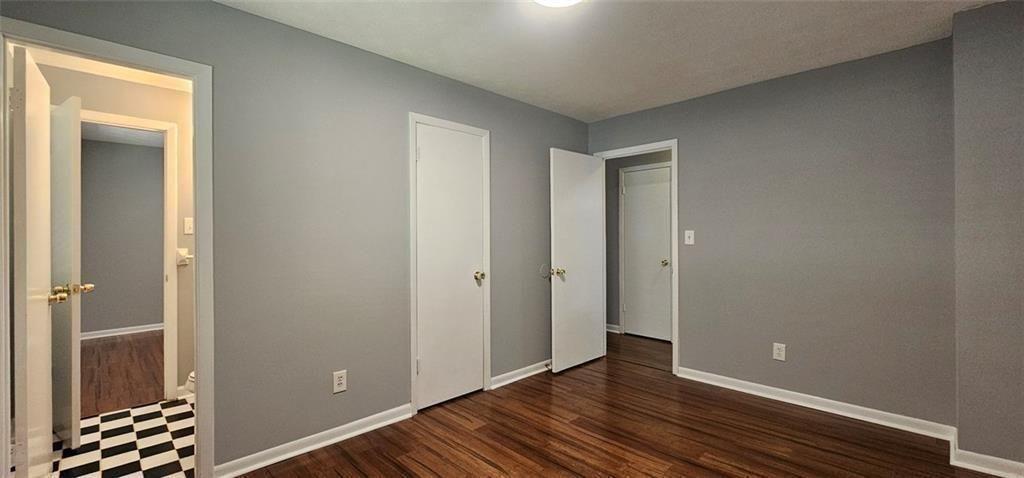 1096 Deleon Court Clarkston, GA 30021 - Photo 26 of 59 a view of an empty room with wooden floor and a window