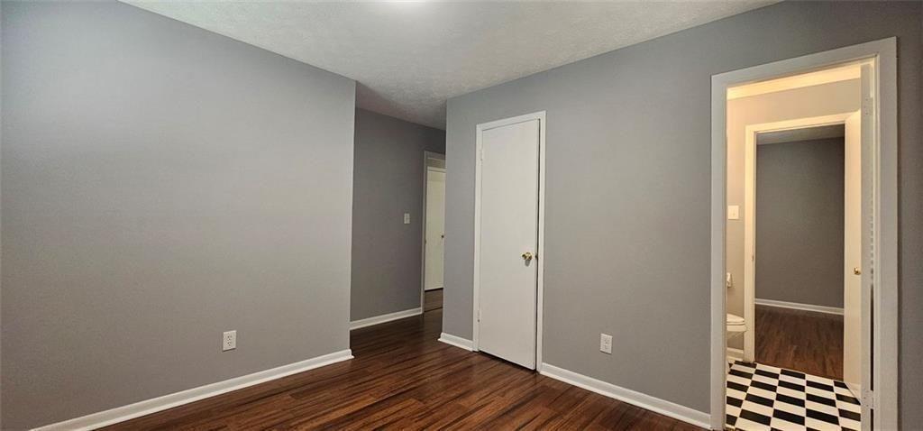 1096 Deleon Court Clarkston, GA 30021 - Photo 30 of 59 a view of room with walk in closet and wooden floor