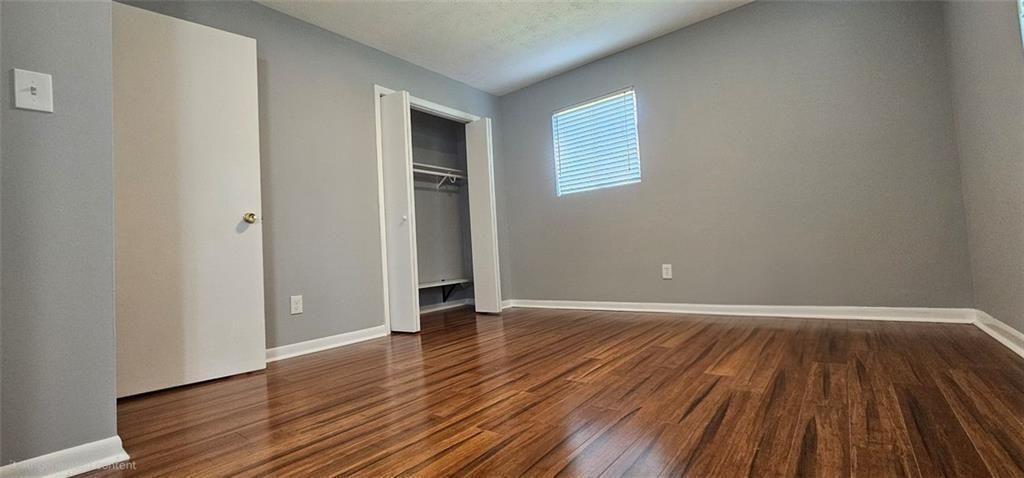 1096 Deleon Court Clarkston, GA 30021 - Photo 33 of 59 an empty room with wooden floor and windows