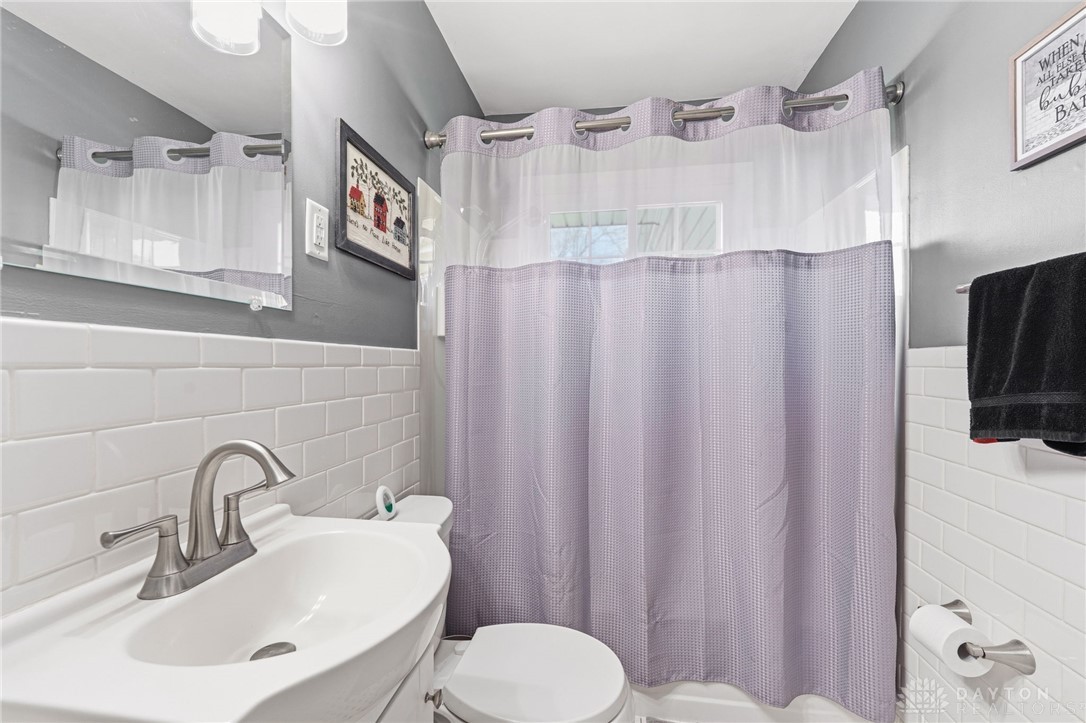2945 Ashlar Drive Springfield, OH 45503 - Photo 13 of 20 This bright bathroom features subway tile, a modern sink, and a convenient shower.