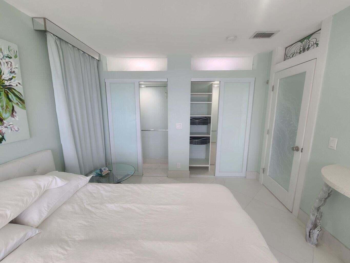 3851 North Ocean Boulevard, Unit 409 Gulf Stream, FL 33483 - Photo 12 of 29 a bedroom with a bed and a bathroom