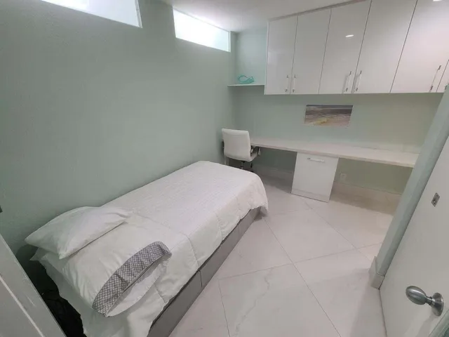 a bedroom with a bed and cabinets