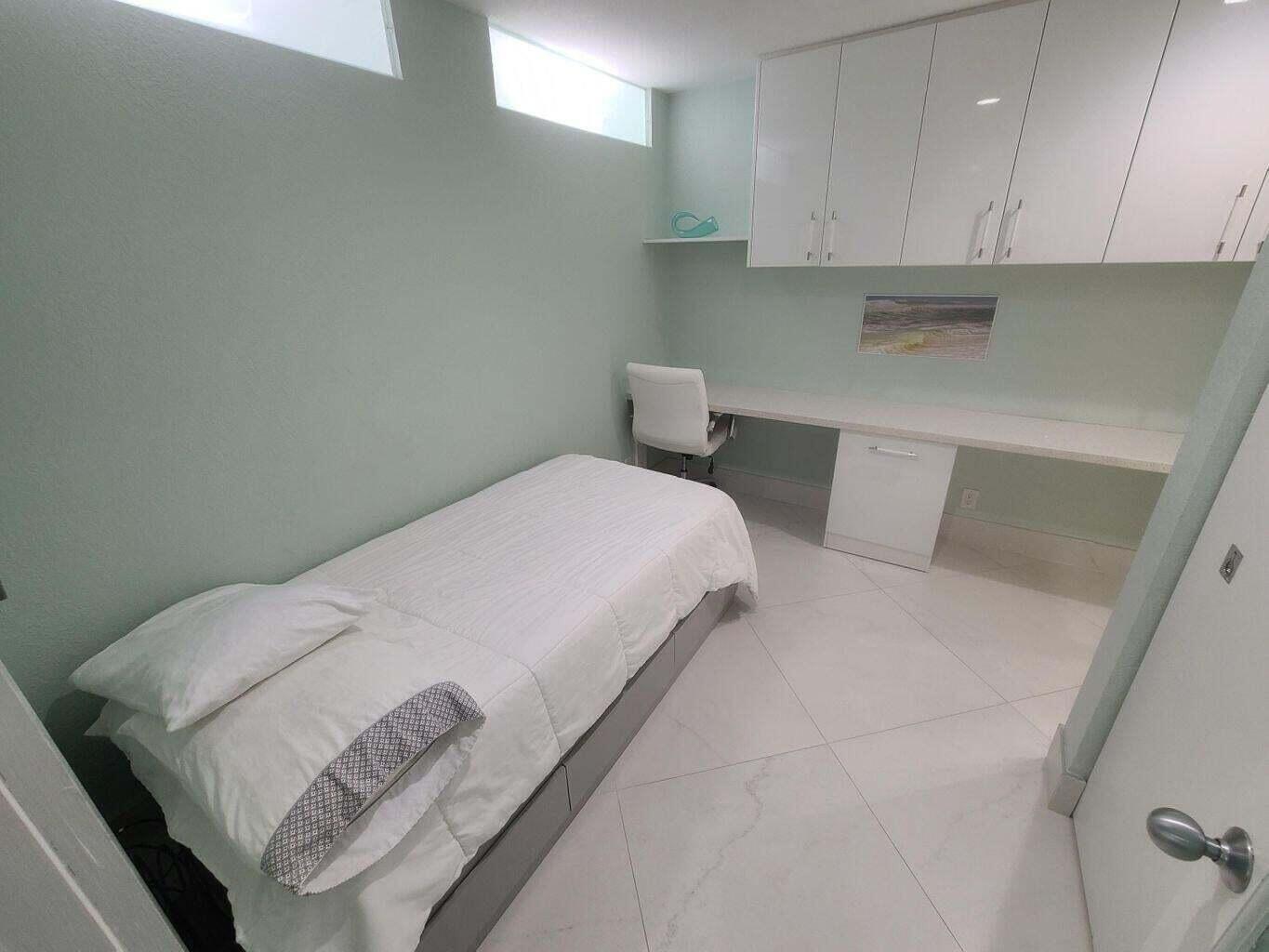 3851 North Ocean Boulevard, Unit 409 Gulf Stream, FL 33483 - Photo 13 of 29 a bedroom with a bed and cabinets