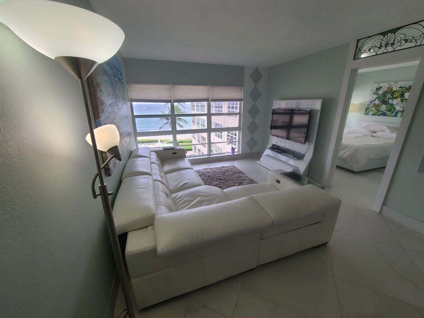 3851 North Ocean Boulevard, Unit 409 Gulf Stream, FL 33483 - Photo 15 of 29 a bedroom with a bed couch and window