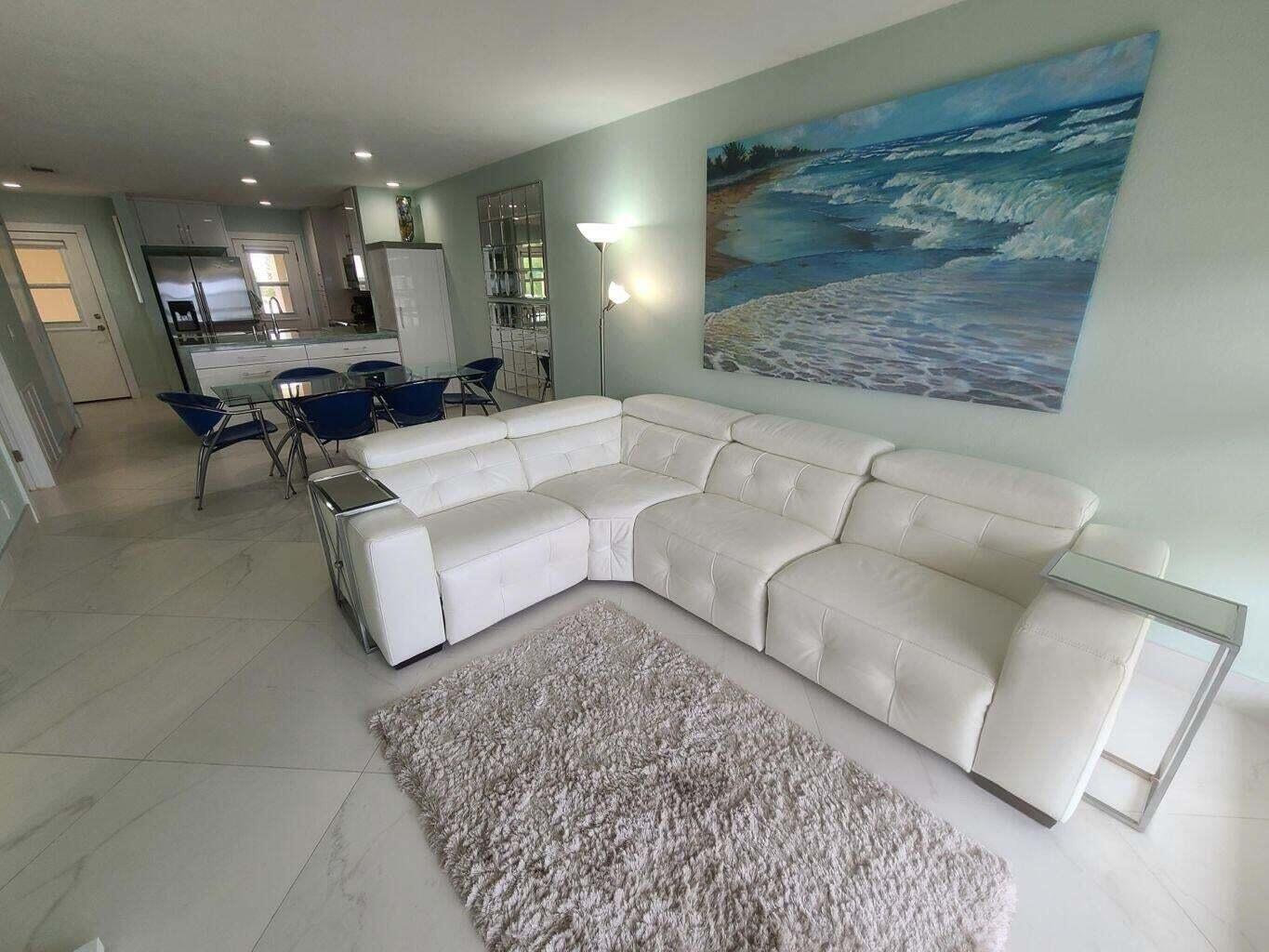 3851 North Ocean Boulevard, Unit 409 Gulf Stream, FL 33483 - Photo 17 of 29 a living room with furniture and a fireplace