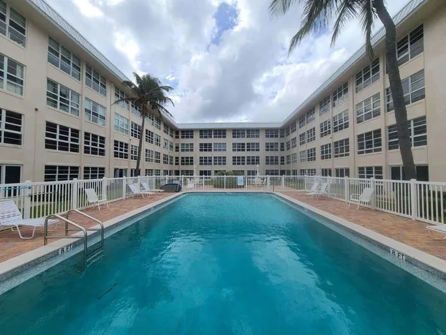 a view of building with a big yard