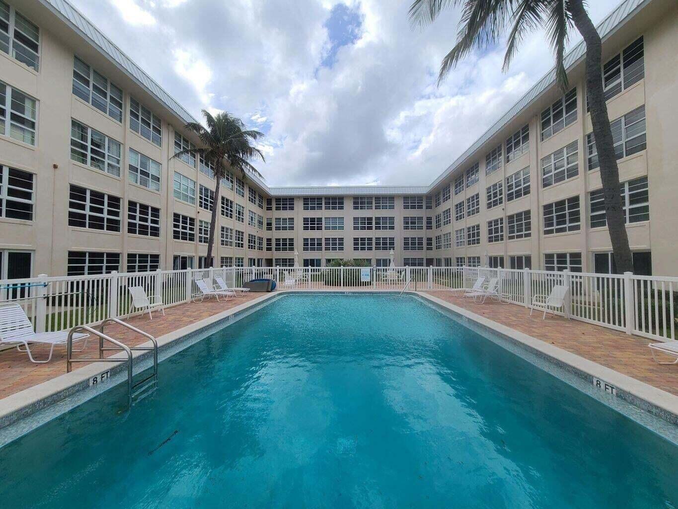 3851 North Ocean Boulevard, Unit 409 Gulf Stream, FL 33483 - Photo 26 of 29 a view of building with a big yard