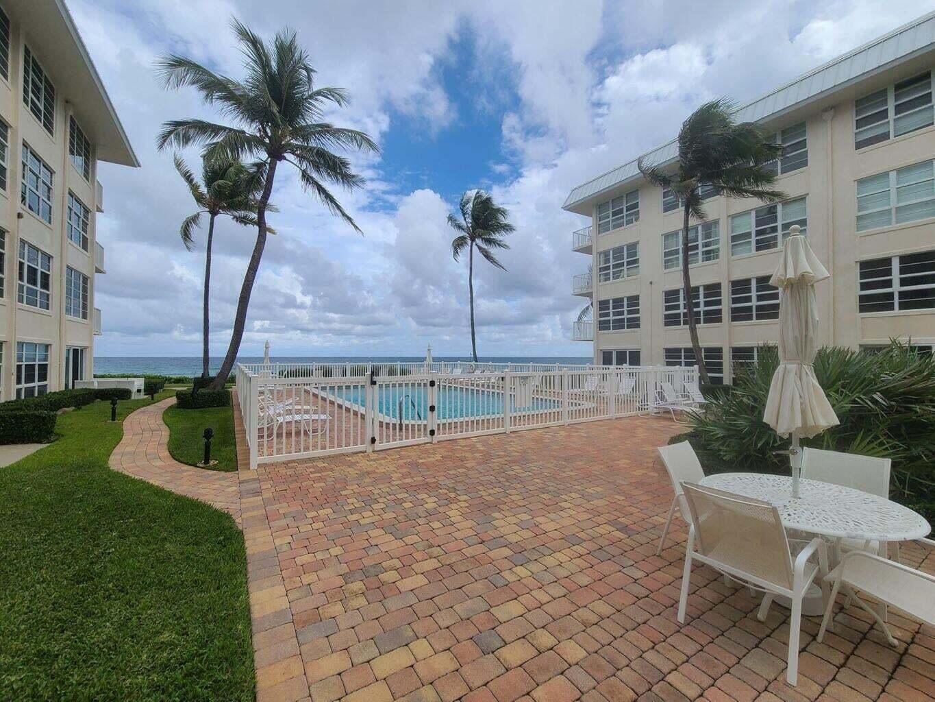 3851 North Ocean Boulevard, Unit 409 Gulf Stream, FL 33483 - Photo 27 of 29 a view of a house with backyard and sitting area
