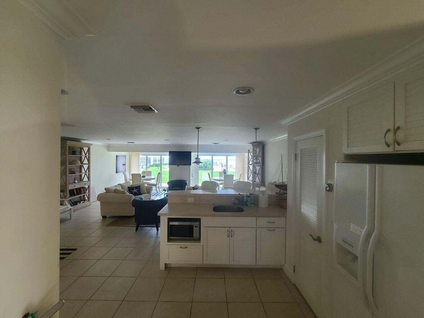 3851 North Ocean Boulevard, Unit 409 Gulf Stream, FL 33483 - Photo 28 of 29 a kitchen with granite countertop lots of counter top space