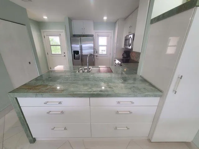 a view of a kitchen cabinets and a sink