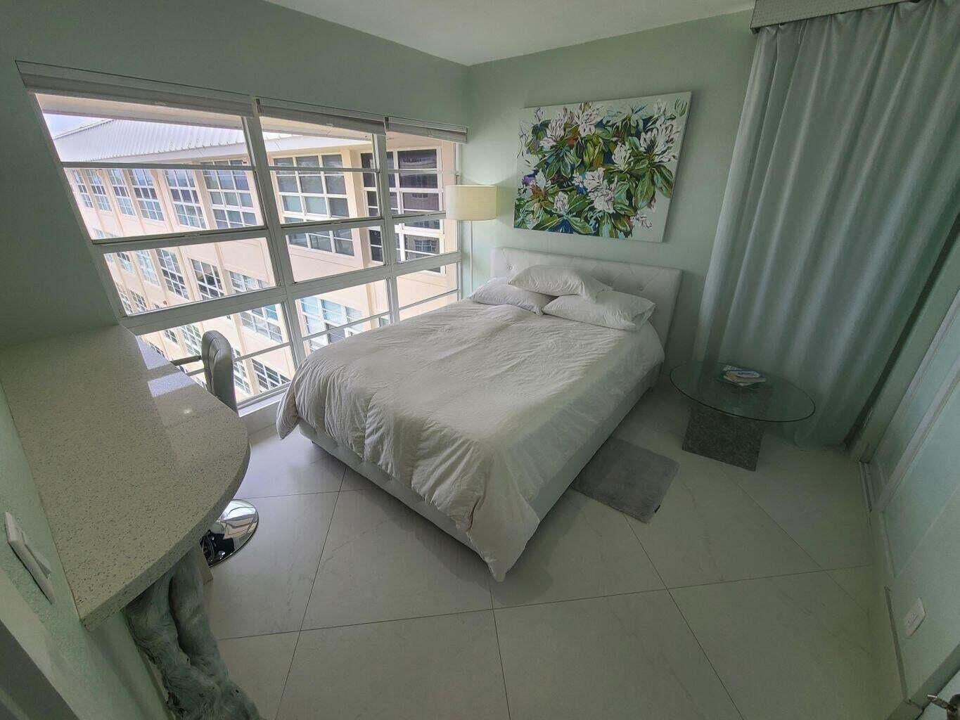 3851 North Ocean Boulevard, Unit 409 Gulf Stream, FL 33483 - Photo 10 of 29 a bed sitting in a bedroom next to a window