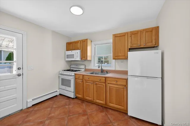 a kitchen with a sink and a refrigerator