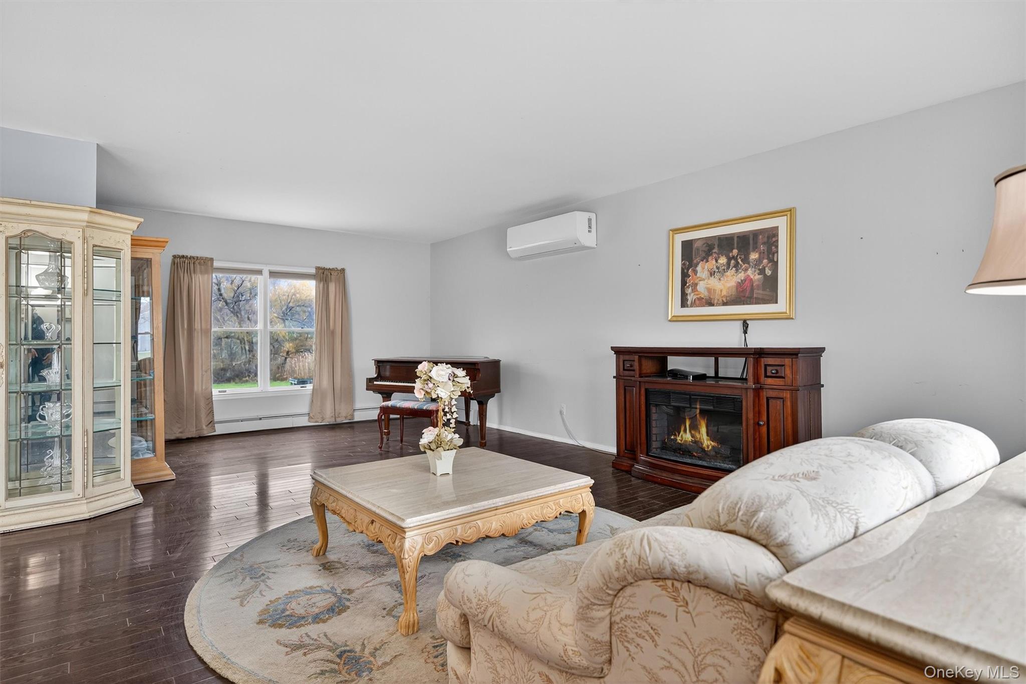 120 Pine Tree Road Monroe, NY 10950 - Photo 12 of 50 a living room with furniture a flat screen tv and a fireplace
