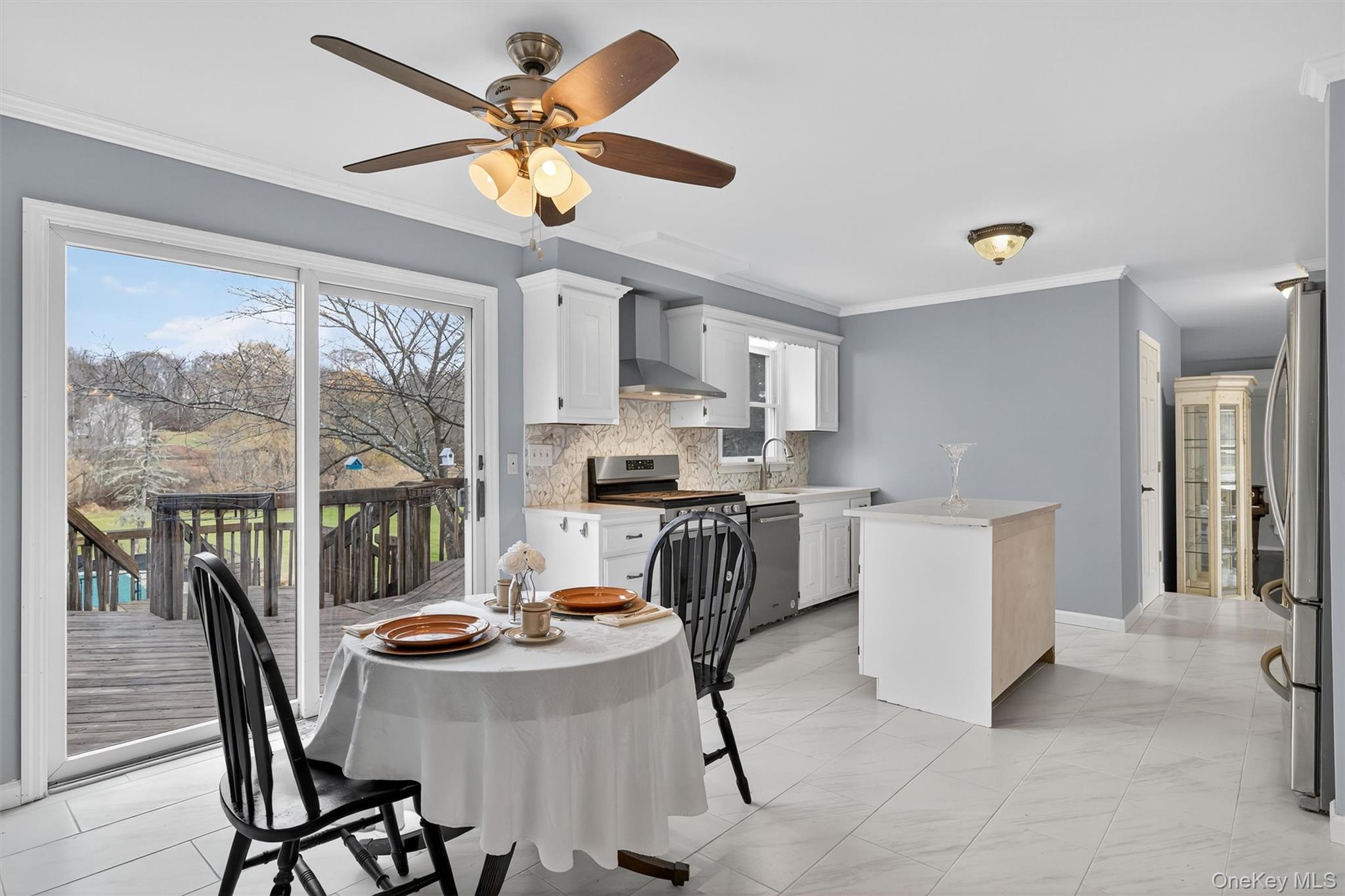 120 Pine Tree Road Monroe, NY 10950 - Photo 13 of 50 a kitchen with a dining table chairs and white appliances