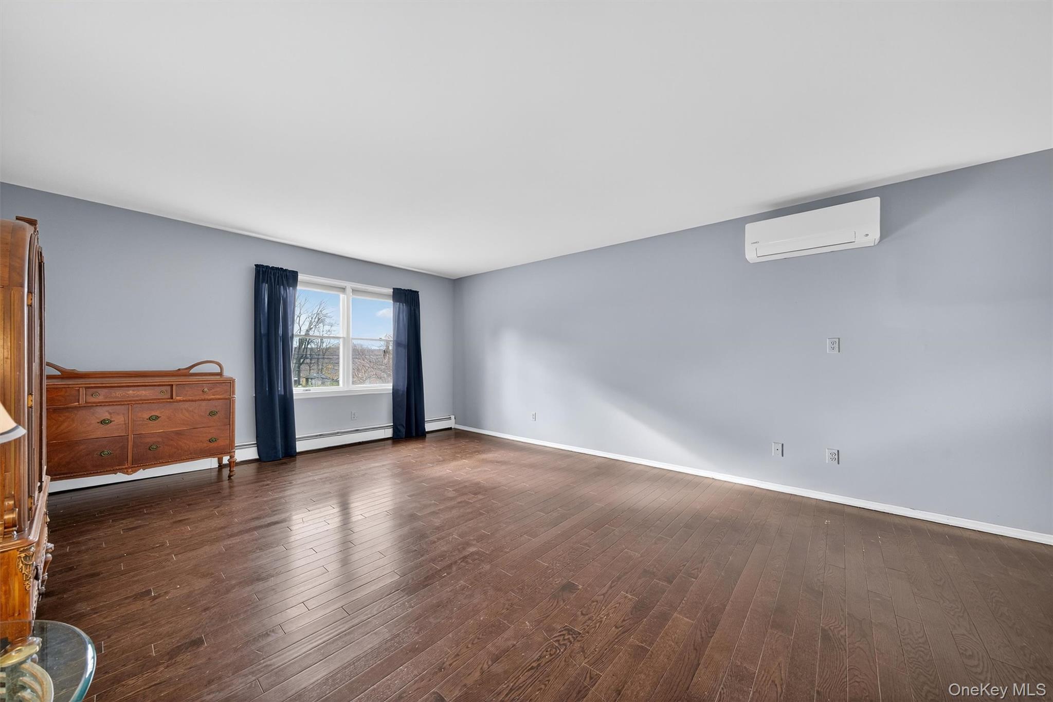 120 Pine Tree Road Monroe, NY 10950 - Photo 22 of 50 an empty room with wooden floor and windows