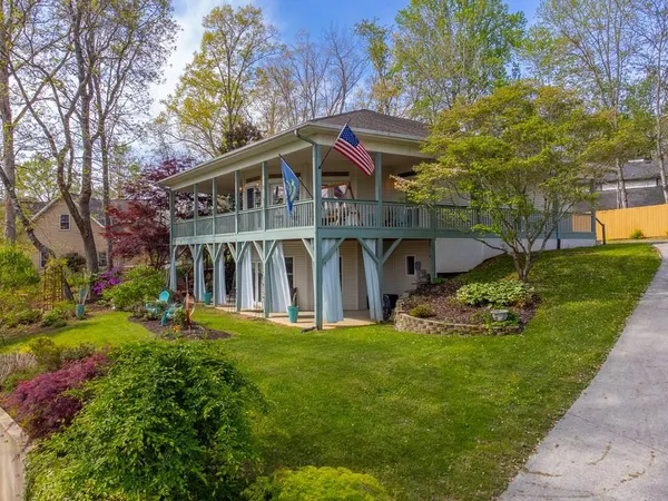 a view of a house with a yard and sitting area