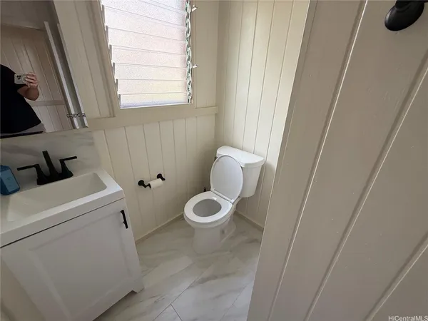 a bathroom with a toilet and a window