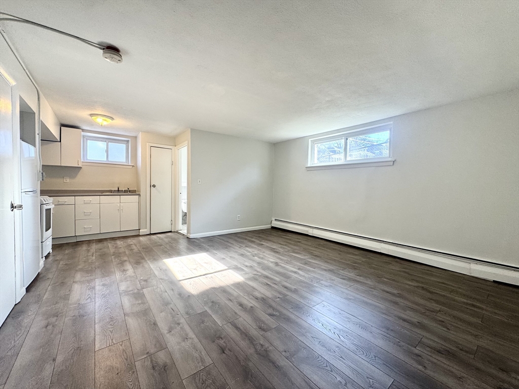 16 Vinal Street, Unit B2 Boston, MA 02135 - Photo 2 of 13 a view of a kitchen with wooden floor and a sink