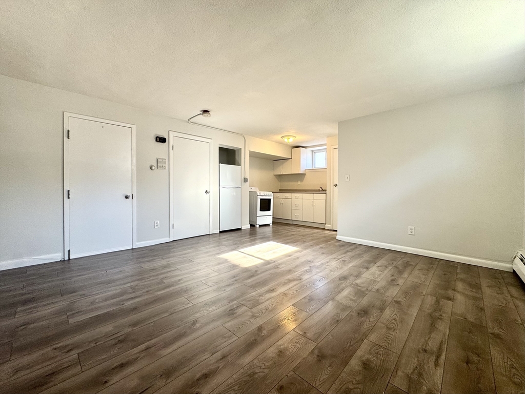 16 Vinal Street, Unit B2 Boston, MA 02135 - Photo 3 of 13 a view of a kitchen with wooden floor