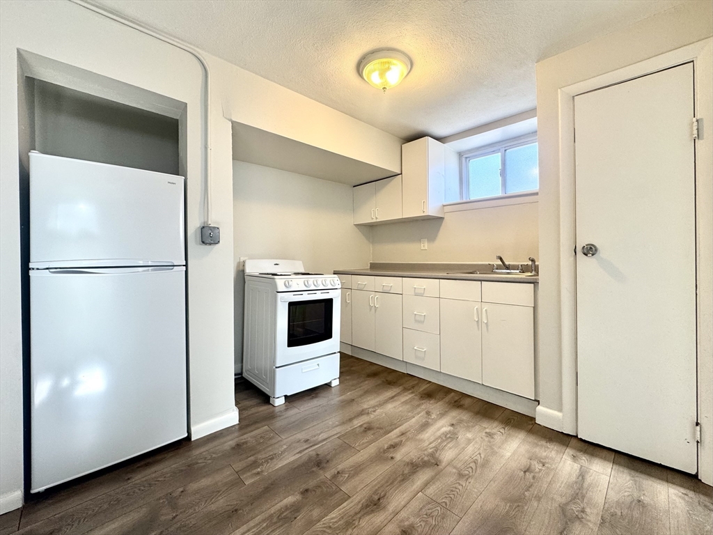 16 Vinal Street, Unit B2 Boston, MA 02135 - Photo 5 of 13 a kitchen with a refrigerator sink and cabinets