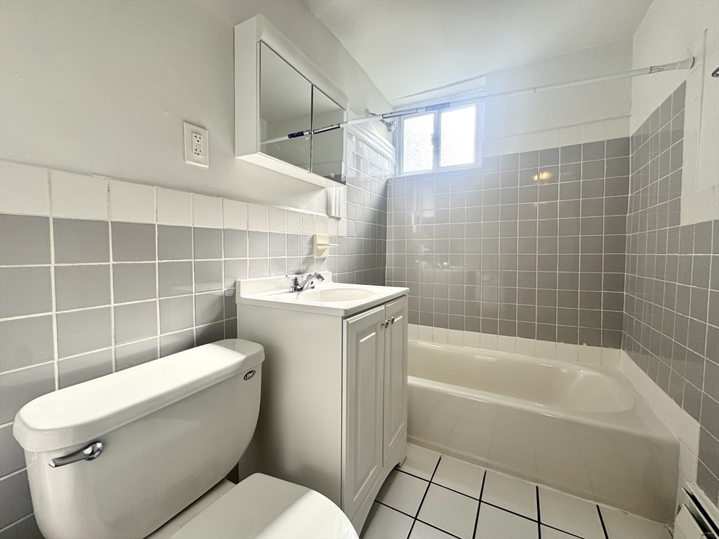 16 Vinal Street, Unit B2 Boston, MA 02135 - Photo 7 of 13 a bathroom with a toilet a sink and bathtub