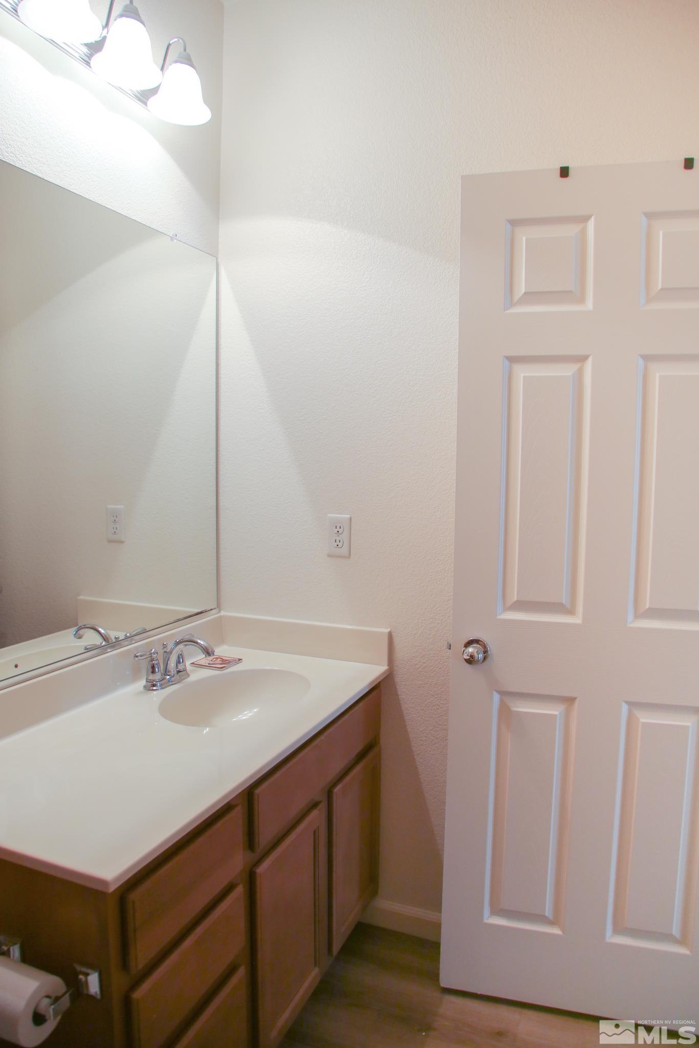 1872 Wind Ranch Road, Unit A Reno, NV 89521 - Photo 18 of 33 a bathroom with a sink and a mirror