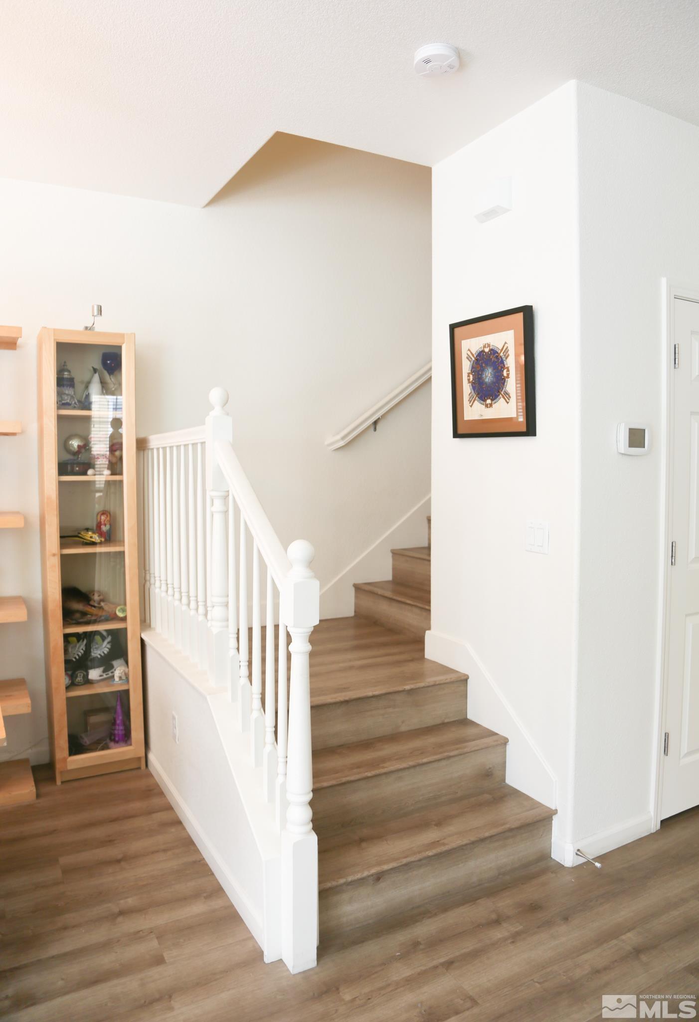1872 Wind Ranch Road, Unit A Reno, NV 89521 - Photo 19 of 33 a view of staircase with wooden floor and a window