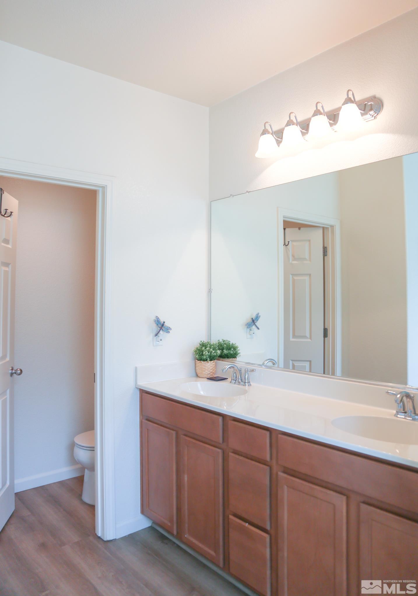 1872 Wind Ranch Road, Unit A Reno, NV 89521 - Photo 22 of 33 a bathroom with a double vanity sink and a mirror