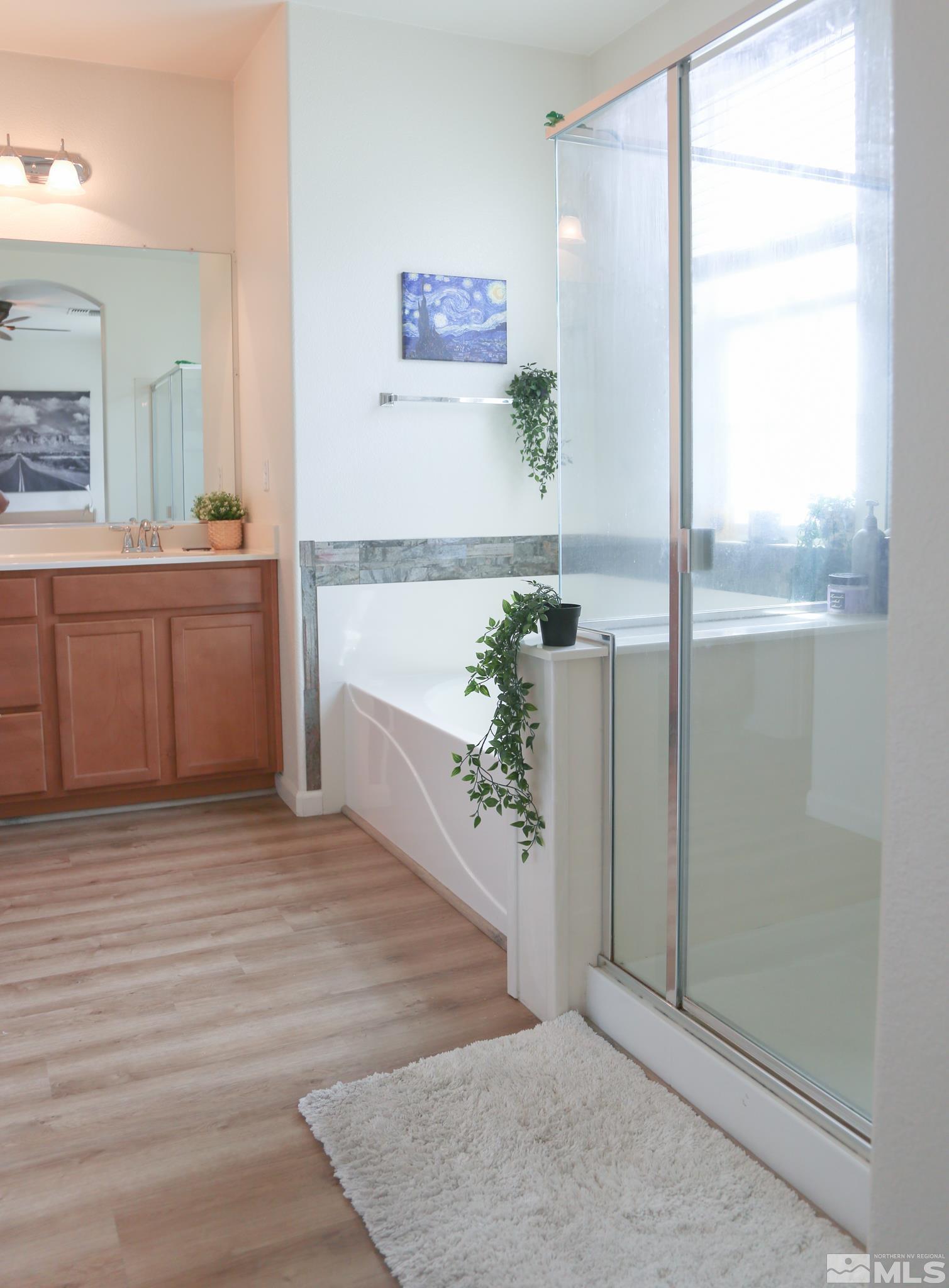 1872 Wind Ranch Road, Unit A Reno, NV 89521 - Photo 23 of 33 a view of a kitchen with wooden floor and a ceiling fan