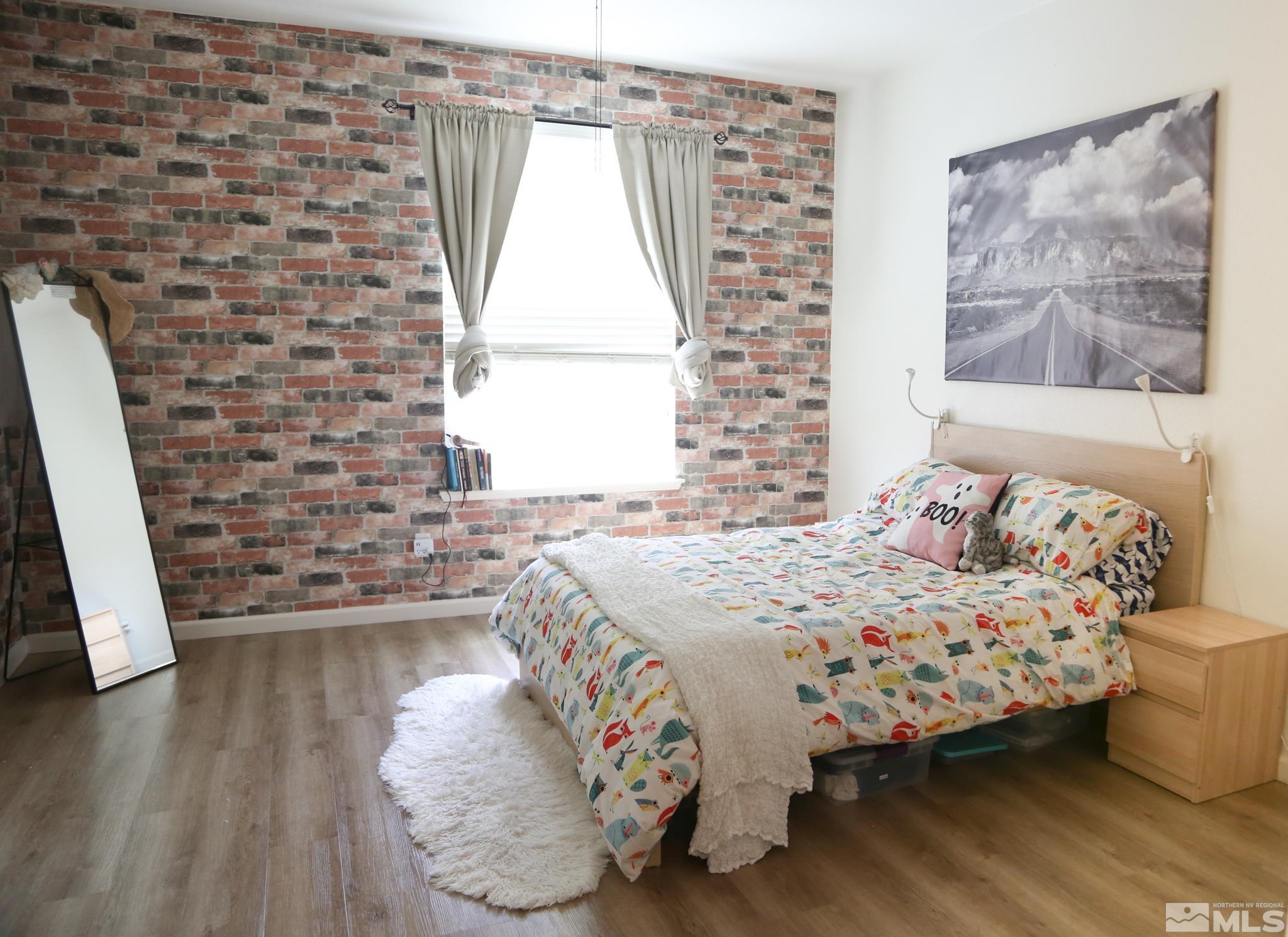 1872 Wind Ranch Road, Unit A Reno, NV 89521 - Photo 27 of 33 a bedroom with a bed and a window