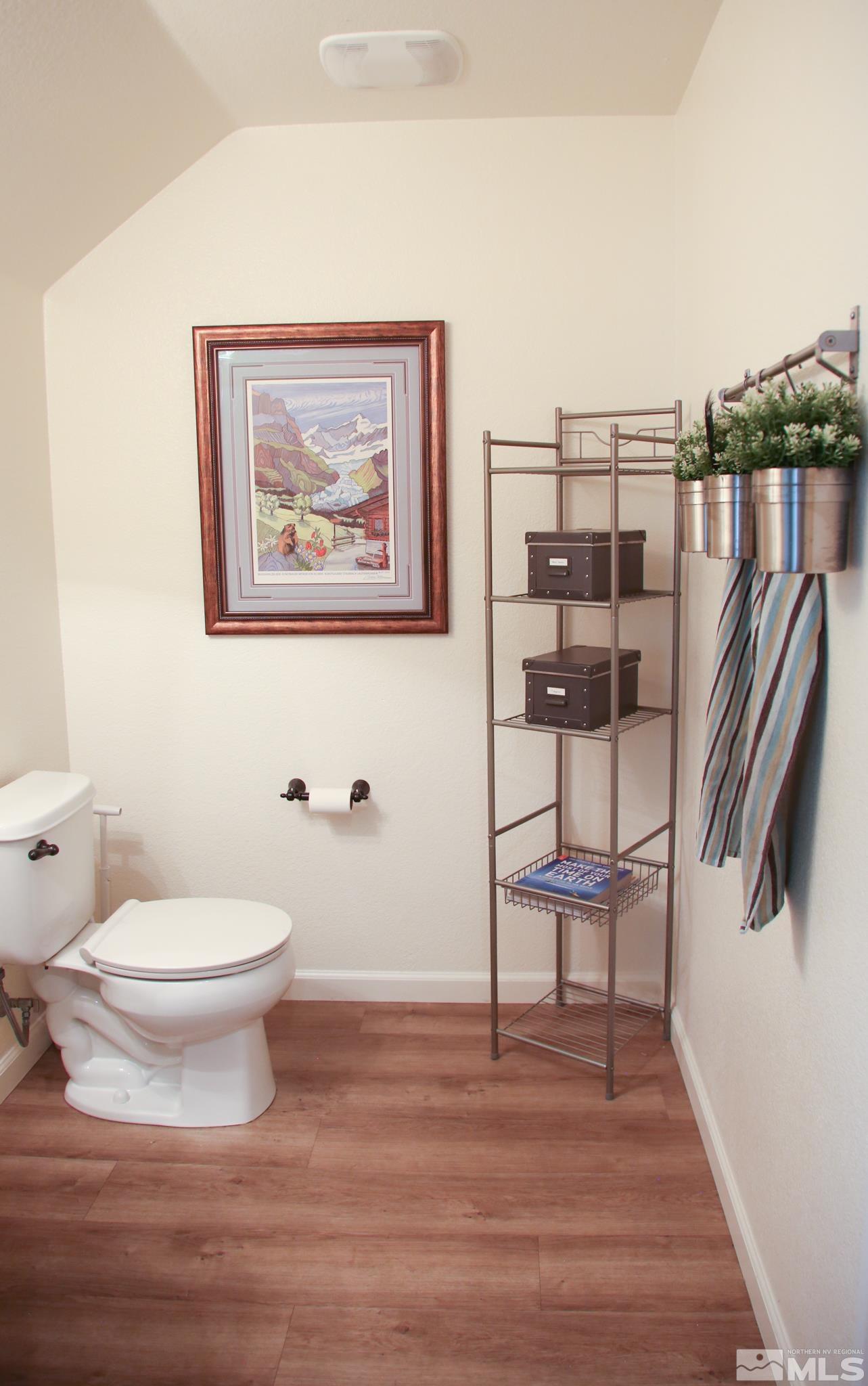 1872 Wind Ranch Road, Unit A Reno, NV 89521 - Photo 28 of 33 a view of a hallway with wooden floor and a potted plant