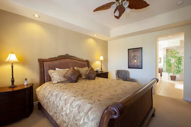 a bedroom with double bed and a chandelier