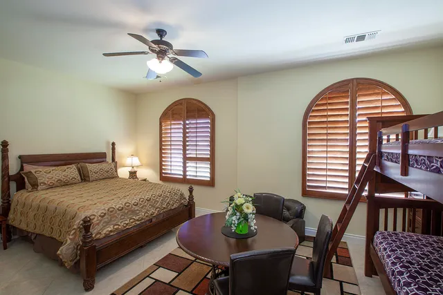 a bedroom with a bed and a chandelier