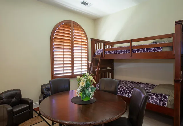 a view of a dining room with furniture and a window