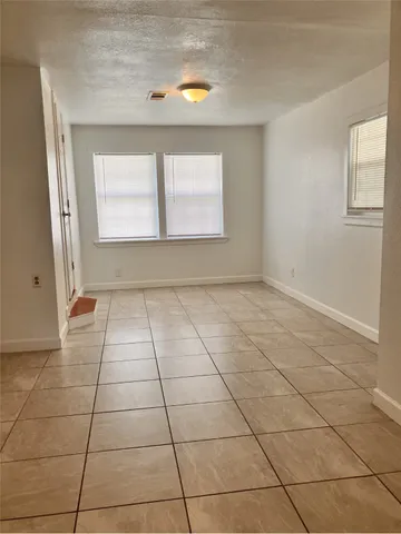 a view of a livingroom with an empty space and a window